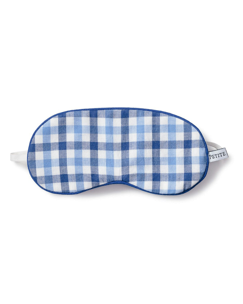 The Kids Twill Sleep Mask in Royal Blue Gingham by Petite Plume features a stylish blue and white checkered design with a comfortable white elastic strap and charming small tag, making it an ideal monogrammed gift for those who appreciate fashionable eye masks.