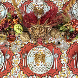 Pumpkin Whitley luxury placemat and napkin on acorn leaves tablecloth with gold napkin bow and Thanksgiving china.