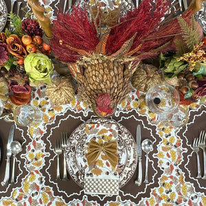 Thanksgiving table setting with turkey centerpiece, fall decorations, and place settings. Acorn leaves hand block printed tablecloth, Whitley placemat and napkin and velvet gold napkin bow ties
