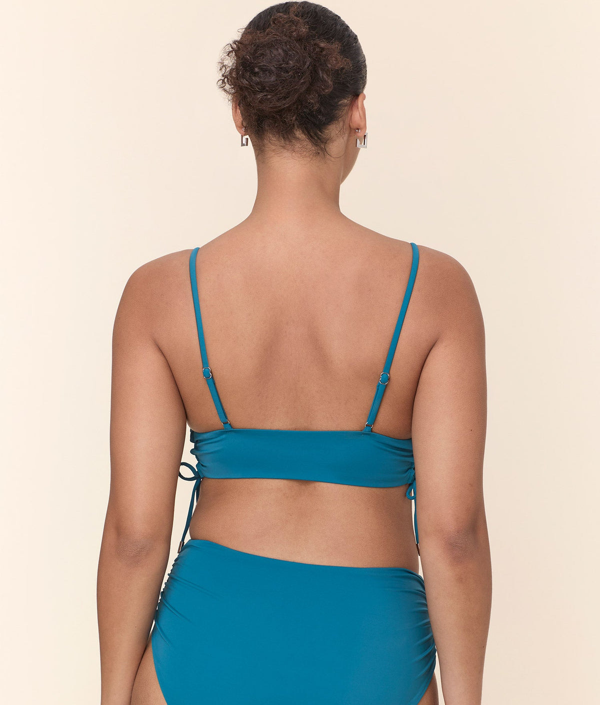 Back view of The Elba Bikini Top - Eco Nylon - Ocean, showcasing adjustable shoulder straps and a secure band for a customizable fit.