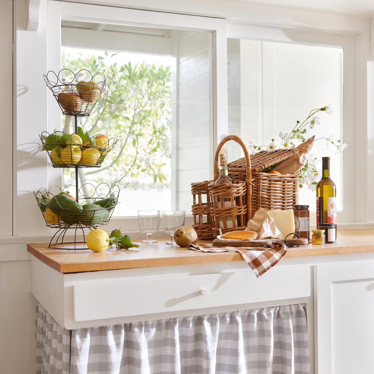 picnic basket on counter next to lemons and limes