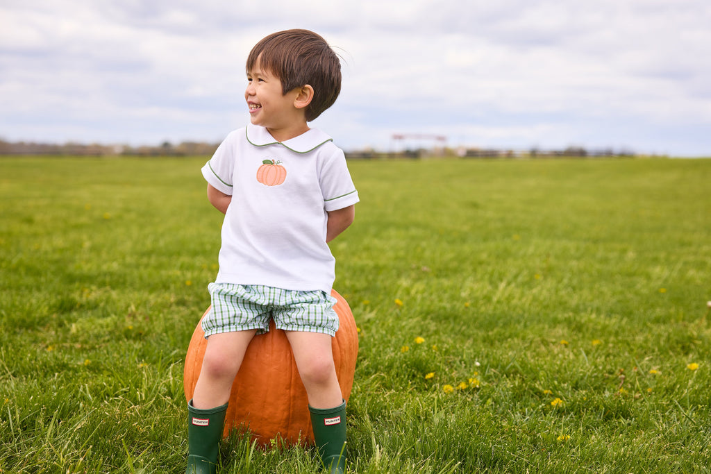 Little English classic short set for little boys.  White knit peter pan shirt with applique pumpkin at the center and coordinating banded shorts in green Leland Plaid.