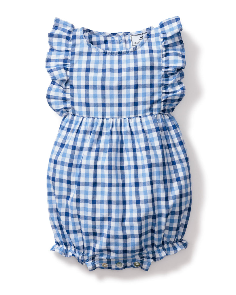 The Babys Twill Ruffled Romper by Petite Plume features a royal blue gingham print with ruffled sleeves and leg openings. This sleeveless romper has a round neckline, gathered waist, and snap buttons at the bottom for easy closure.