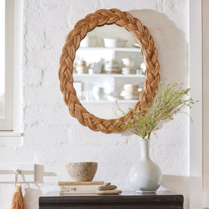 oval mirror against a white wall