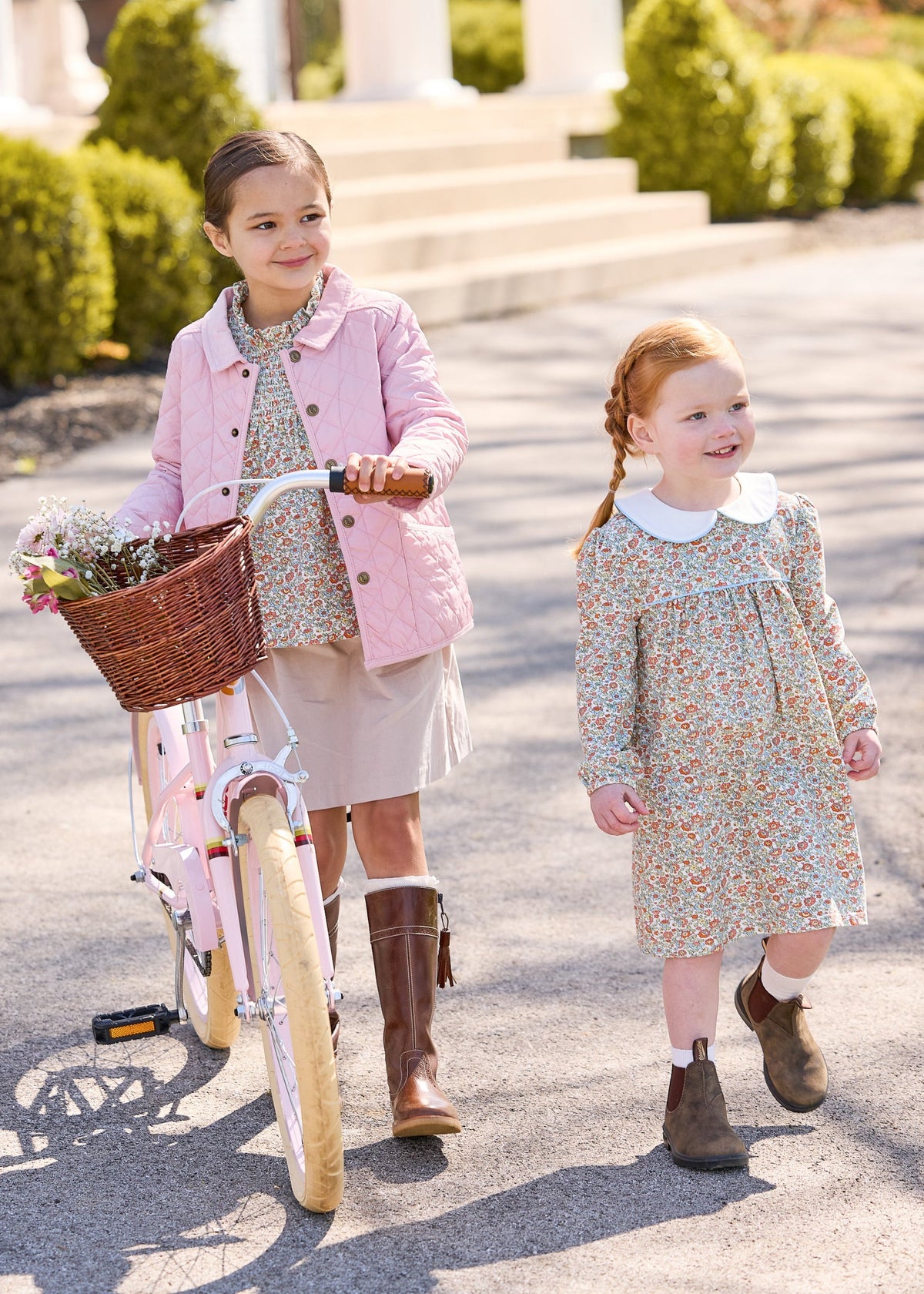 Little english classic childrens clothing, quilted jacket in light pink, hallie top in orange, blue, and green james floral, paperbag bow skirt in stone corduroy, evelyn dress in james floral, coordinating fall outfits for sisters