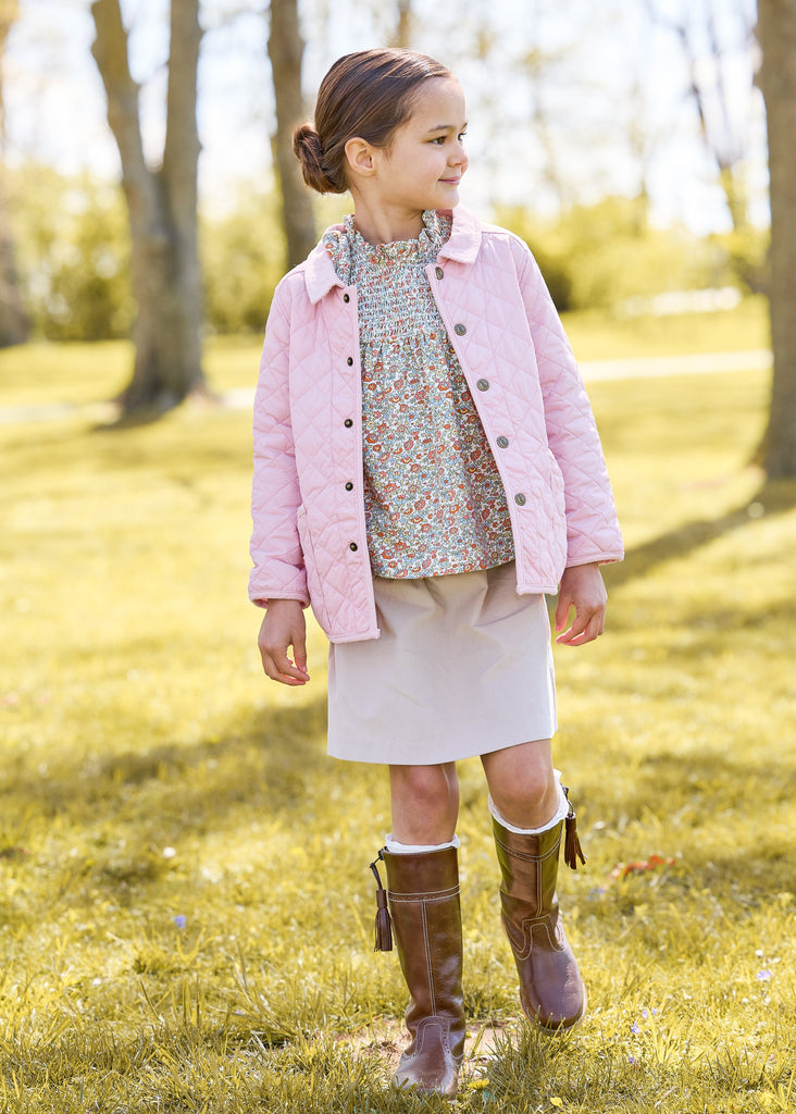 Little english classic childrens clothing, quilted jacket in light pink, hallie top in orange, blue, and green james floral, paperbag bow skirt in stone corduroy