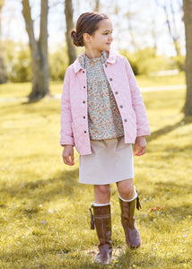 Little english classic childrens clothing, quilted jacket in light pink, hallie top in orange, blue, and green james floral, paperbag bow skirt in stone corduroy