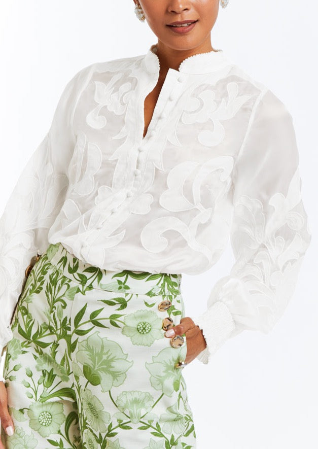 Linen blouse with full length bishop sleeves, functional buttons, and embroidered flourishes.