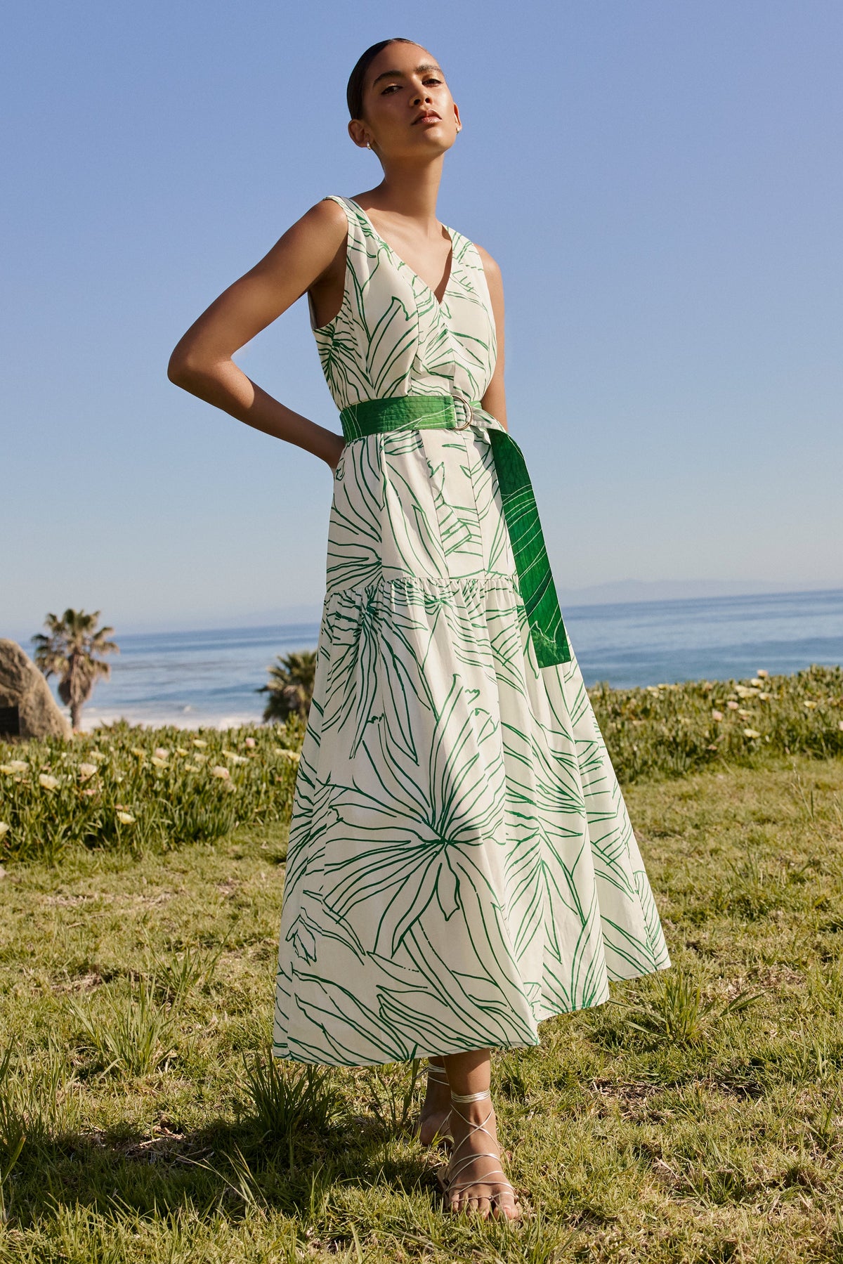 Sleeveless midi dress with green tropical leaf print and belted waist