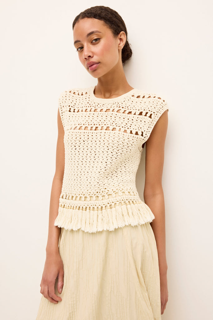 Textured ivory tank with intricate crochet pattern and tassel trim