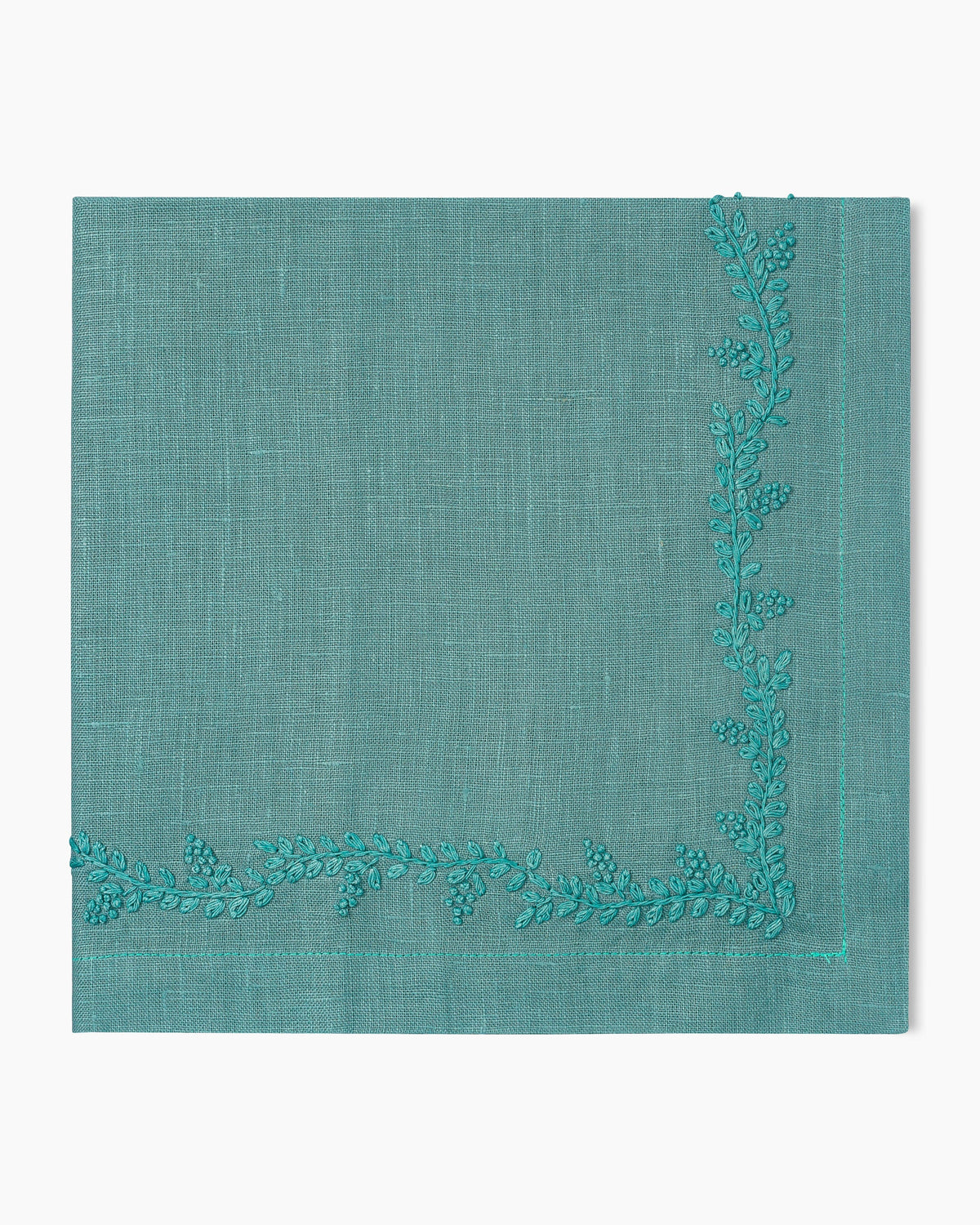 A Prism Vine Dinner Napkin with embroidered leaves, made of linen.