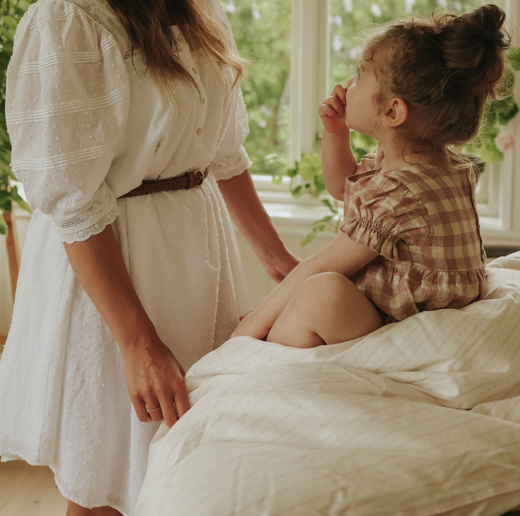 Petal Scallop Baby Duvet with child sitting on top with mother by side