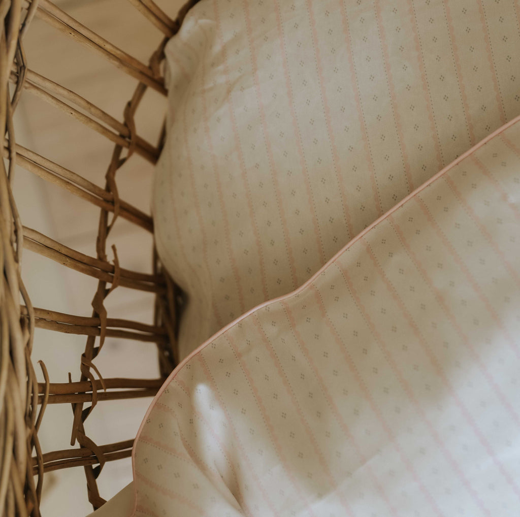Petal Scallops Baby Duvet in Pink displayed in bassinet