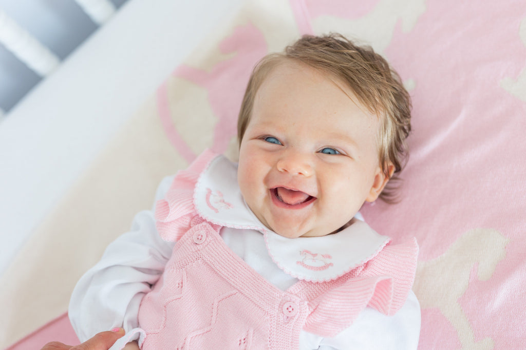 little english classic children's clothing baby girls light pink pointelle knit bubble with ruffle sleeve, pinpoint onesie with pink rocking horse motif. For baby girl