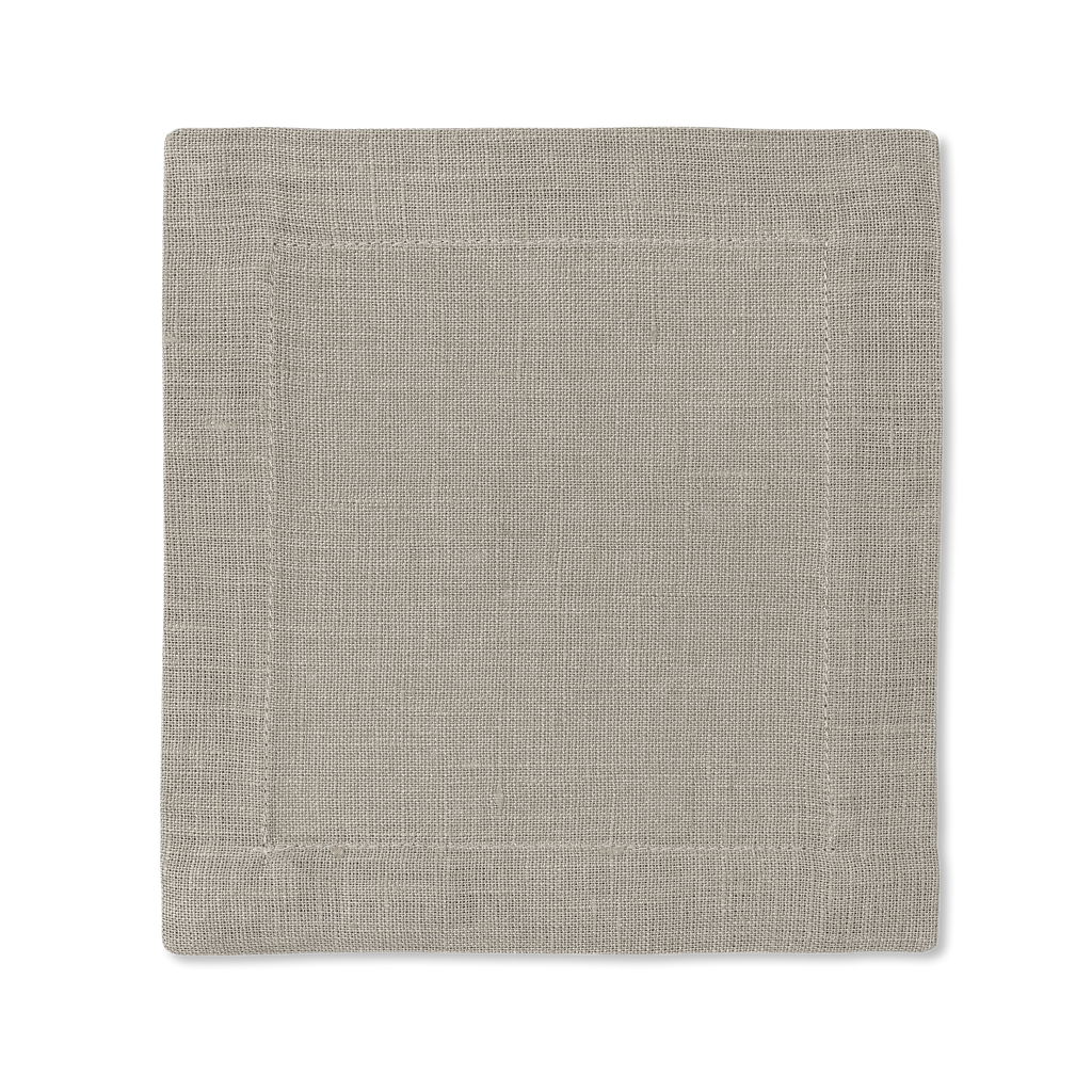 A square linen cocktail napkin in the color sand
