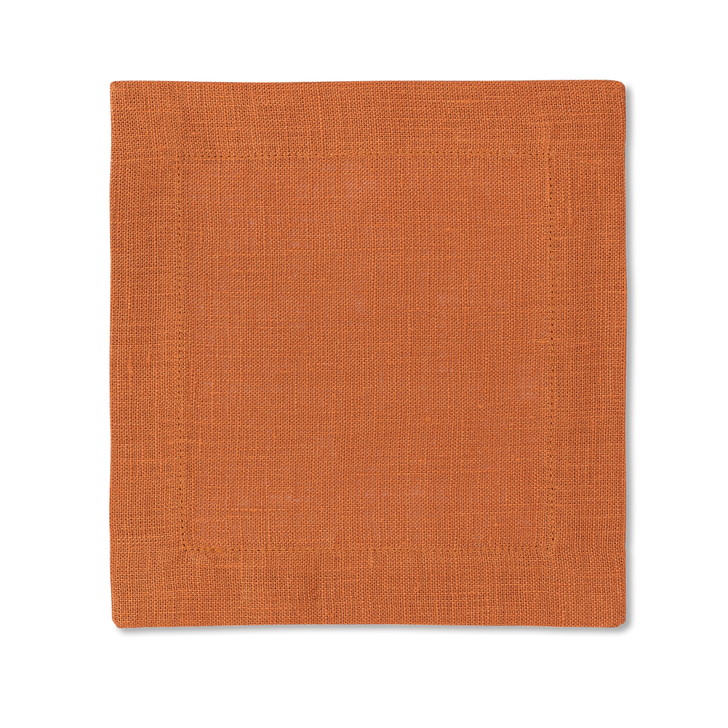 A square linen cocktail napkin in the color tangerine