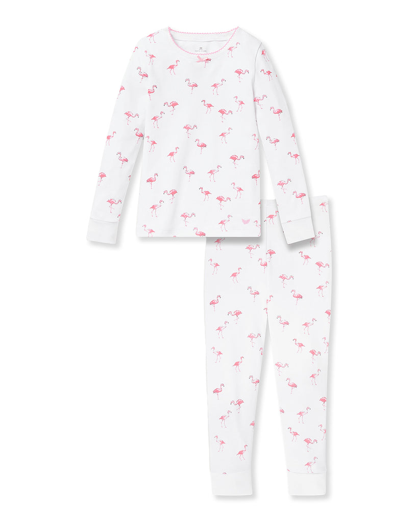 The Kid’s Pima Snug Fit Pajama Set in Flamingo by Petite Plume features a white long-sleeve top and pants with a pink flamingo pattern, perfect for cozy nights and coordinating with our family sleepwear collection.