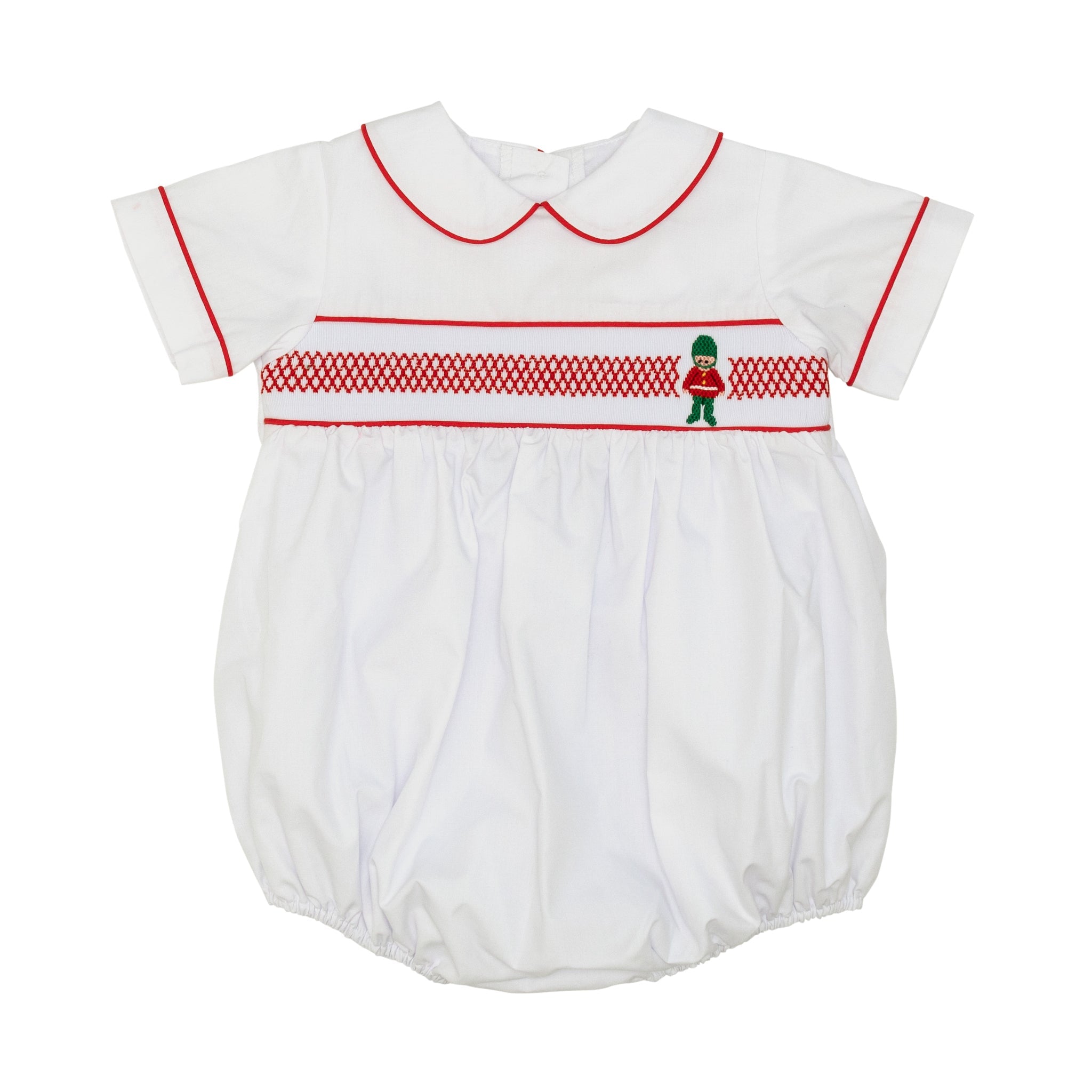 White baby boy holiday bubble with red toy soldier smocking and Peter Pan collar, Henry Duvall's Charlie Bubble in cotton poplin for Christmas celebrations