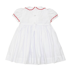 White short sleeve girls' holiday dress with red bow smocking across the chest, Peter Pan collar, and piped cuffs, classic Henry Duvall Eloise Dress for Christmas and winter family gatherings
