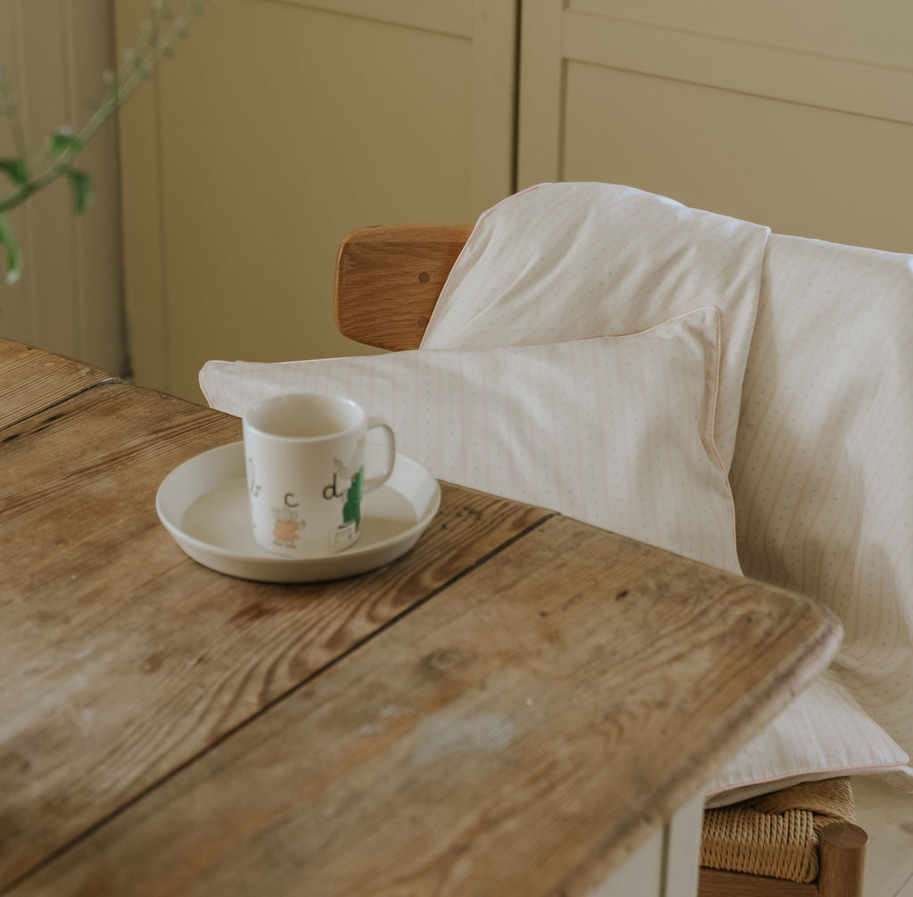 Petal Scallops Toddler Duvet and Pillow hanging over chair