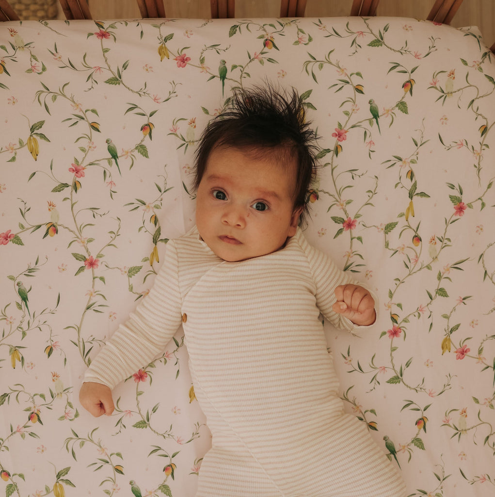 Dreaming of Paradise Crib Sheet with baby laying on top.