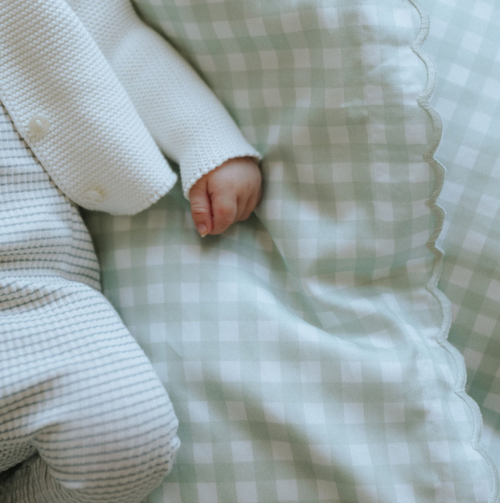 Picnic Gingham Green Baby Duvet with sleeping baby laying on top