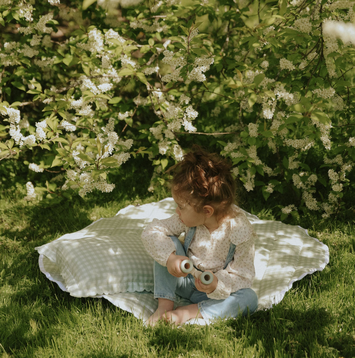 Picnic Gingham Green Playmat with a toddler playing