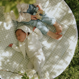 Picnic Gingham Green Playmat with a baby sleeping and toddler playing