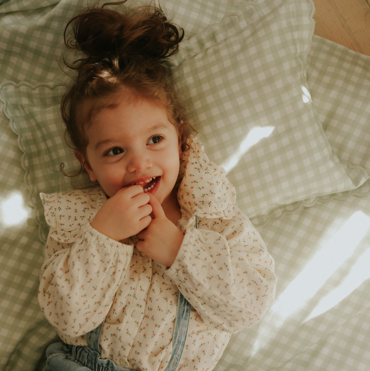 Picnic Gingham Green Toddler Pillow with little girl laying on top