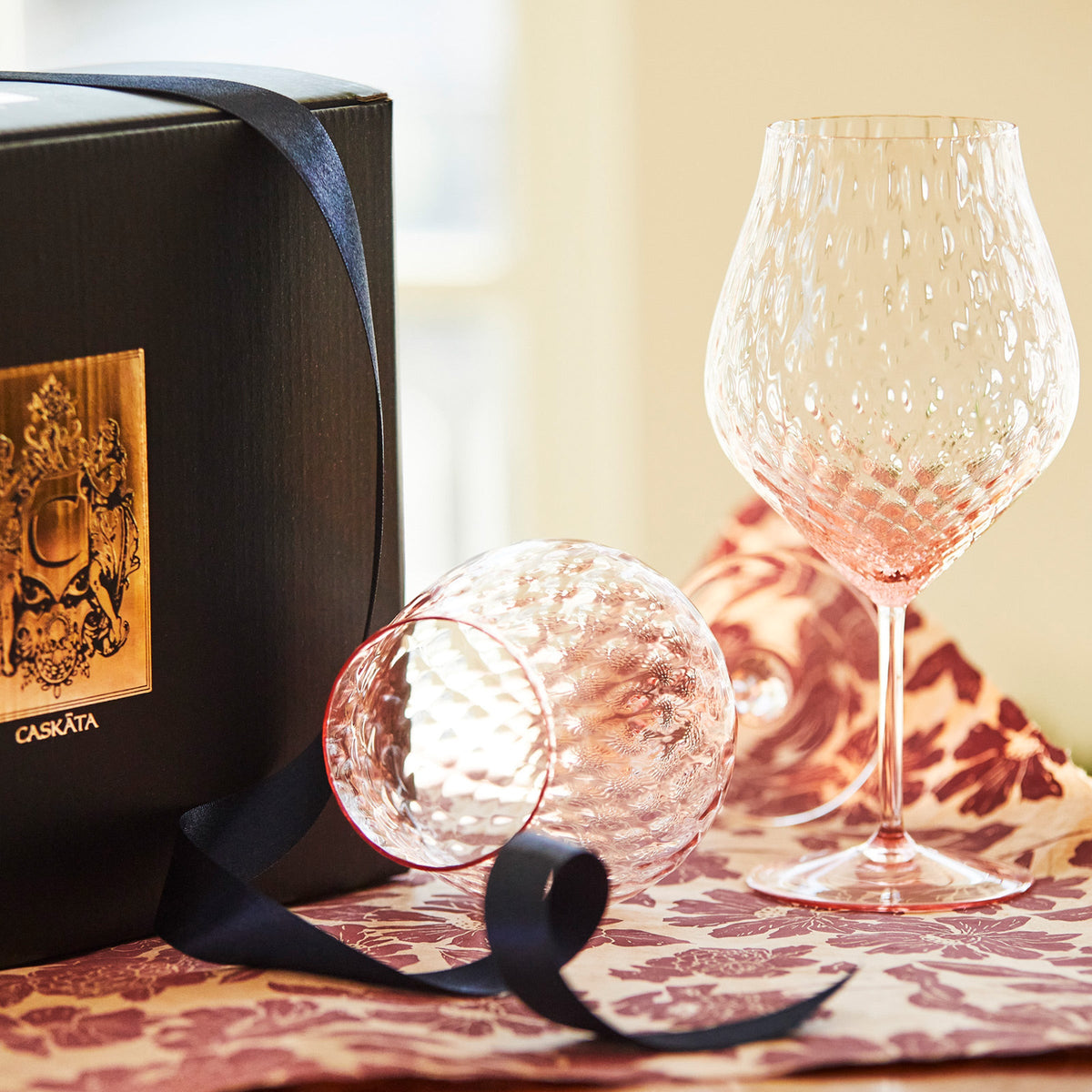 Phoebe rose pink mouth blown diamond optic crystal glasses from Caskata, universal wine glasses pictured.