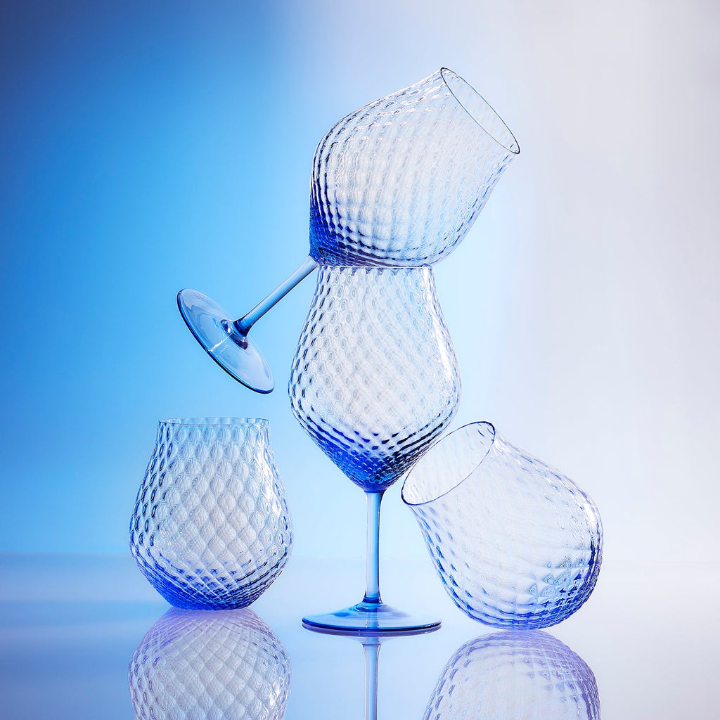 Phoebe cobalt blue mouth blown diamond optic crystal glasses from Caskata, both universal stemware and stemless wine glasses pictured.