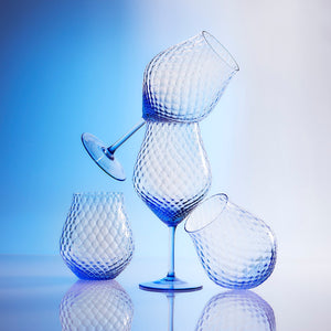 Phoebe cobalt blue mouth blown diamond optic crystal glasses from Caskata, both universal stemware and stemless wine glasses pictured.