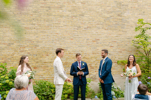 The Grooms Walked Down the Aisle to an Acoustic Version of Dolly Parton's "Here to the Moon and Back"