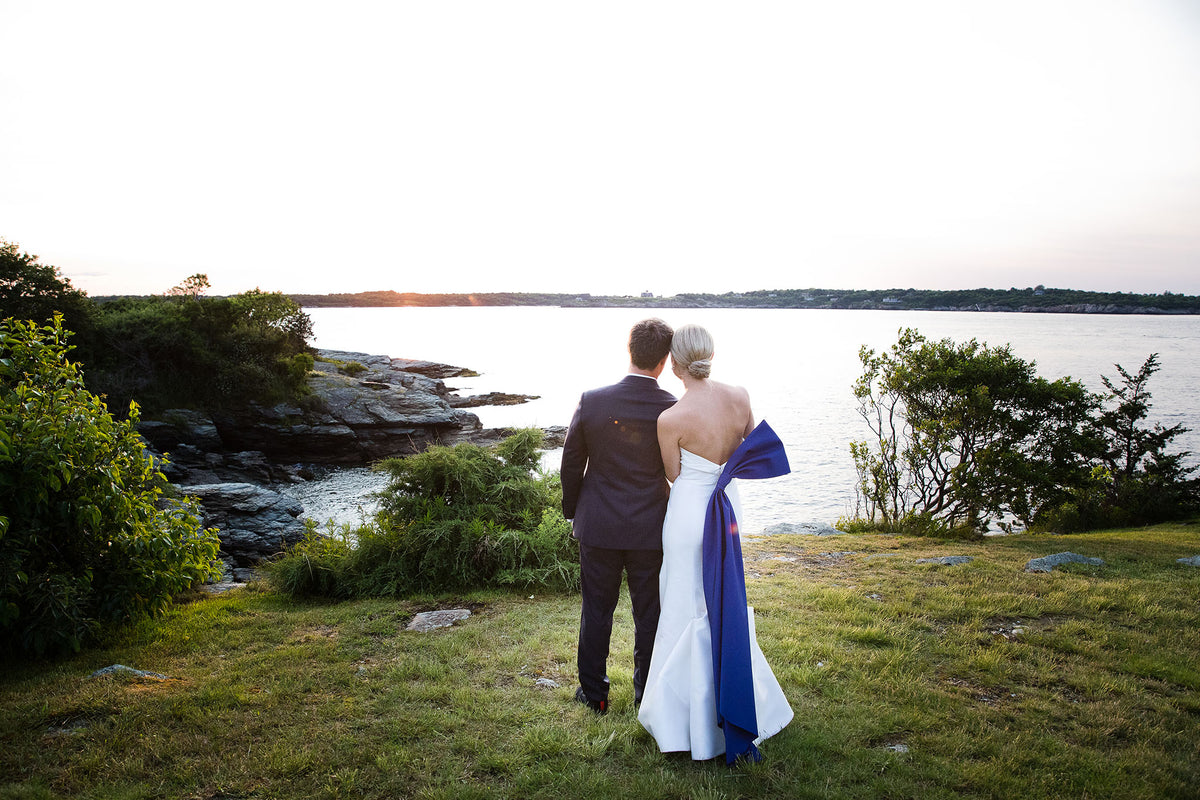 This Bride Wore A Carolina Herrera Dress with a Dramatic Blue Sash to Her Wedding at the Iconic Castle Hill Inn