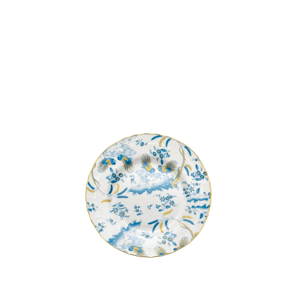 Top-down view of Oro Di Doccia dessert plate showcasing blue floral and rooster pattern, scalloped edge and gold rim on white background