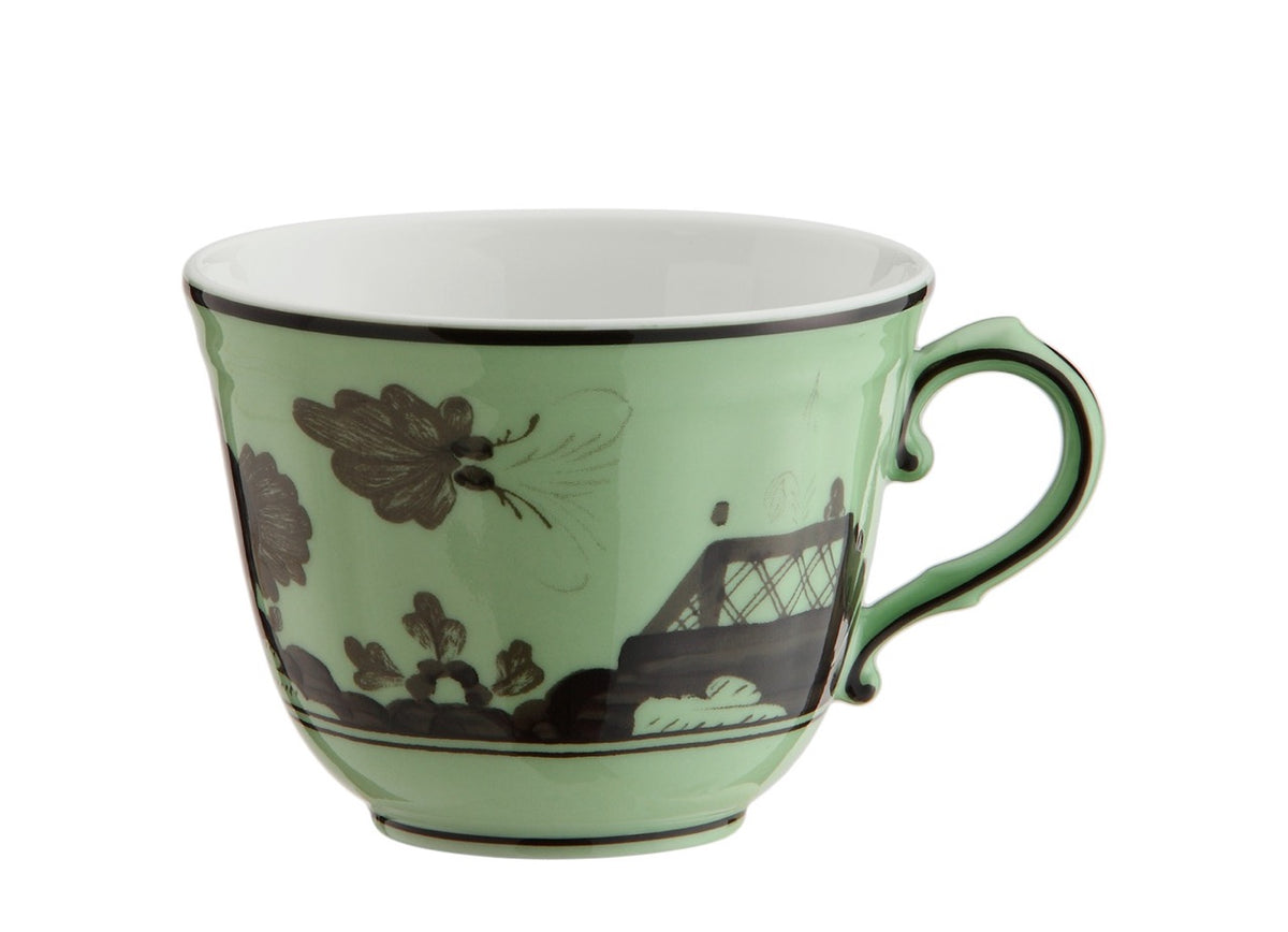 Side view of Oriente Italiano tea cup in Bario showing pale green porcelain with dark brown floral and lattice pattern on white background