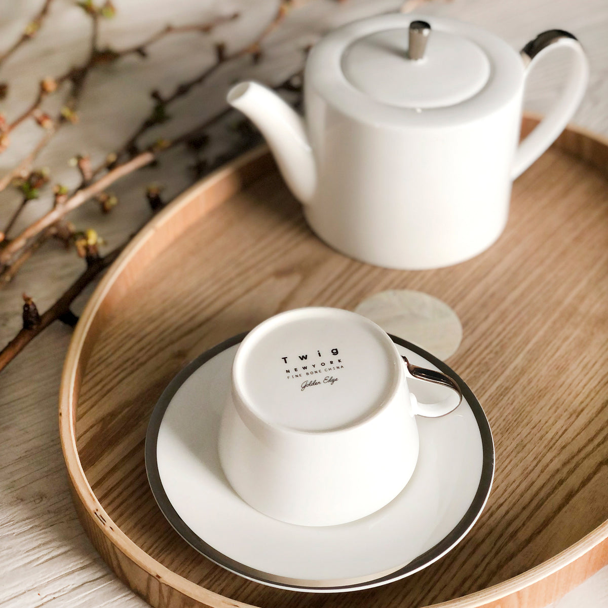 Close-up of Platinum Edge Teapot showcasing hand-painted platinum accents with tea service on a wooden tray