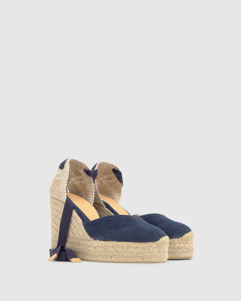 Three-quarter view of Chiara 8ED espadrille wedge in Oxford Blue with jute double platform and ankle wrap ties on light gray background