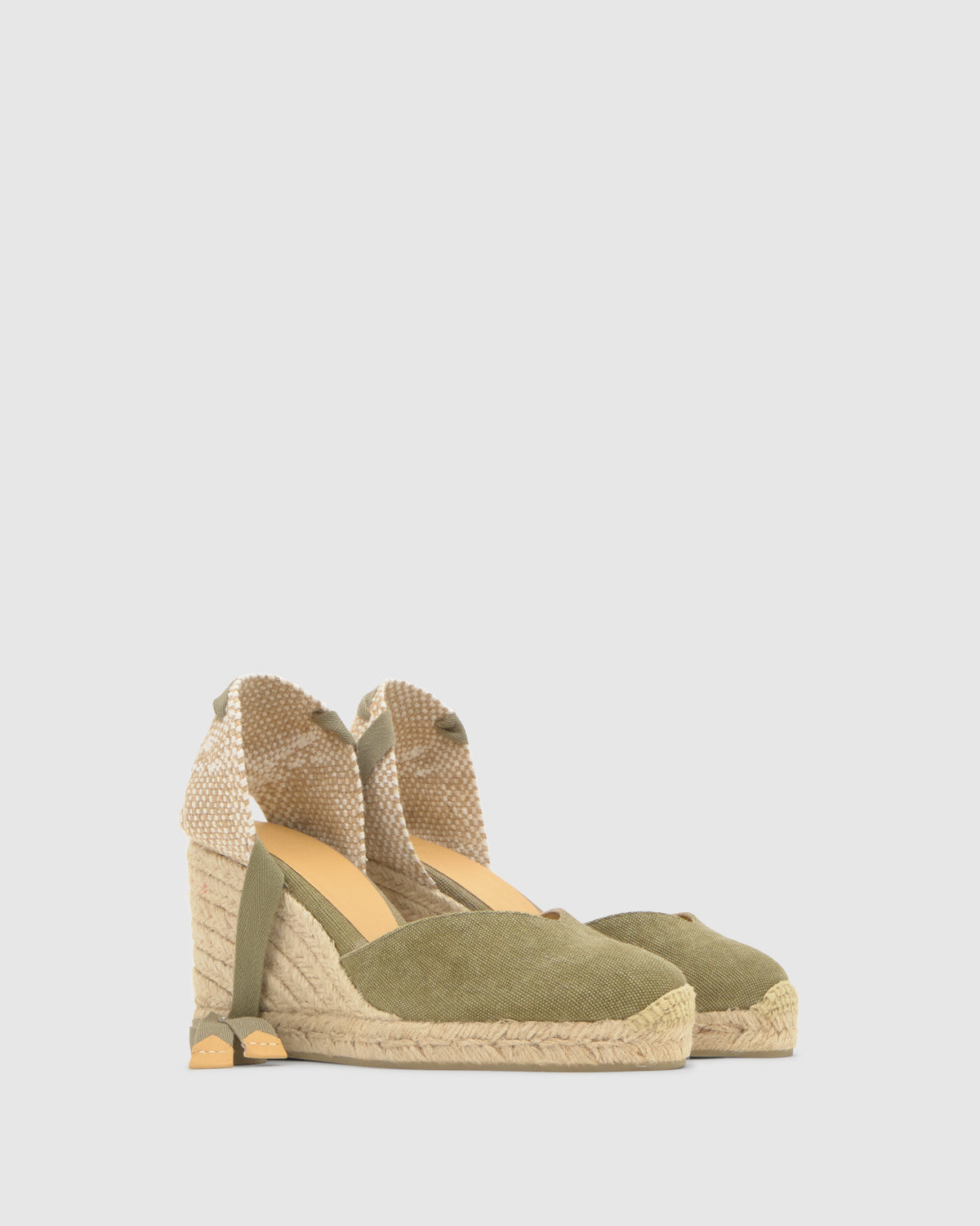 Three-quarter view of Chiara 8 wedge espadrilles in laurel with olive canvas upper, jute wedge, and ankle wrap on light gray background