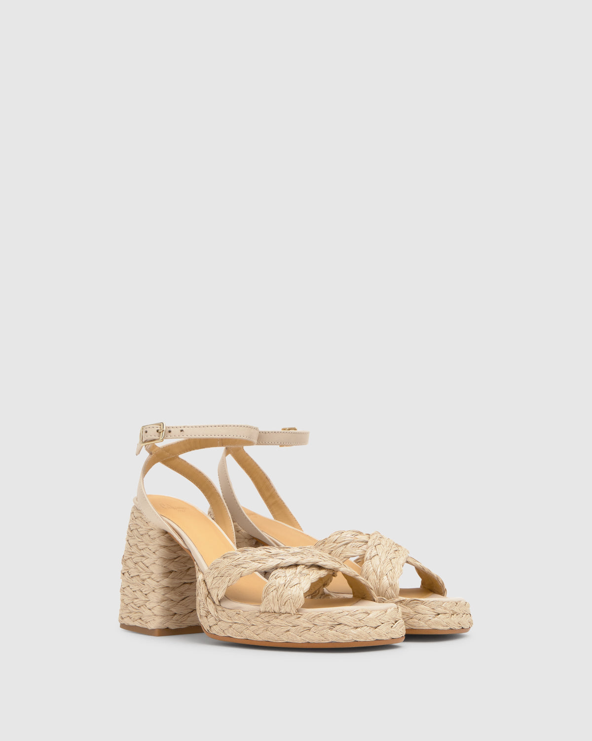 Three-quarter view of Valeriette sandal in ecru showing braided raffia platform, block heel, and ankle buckle