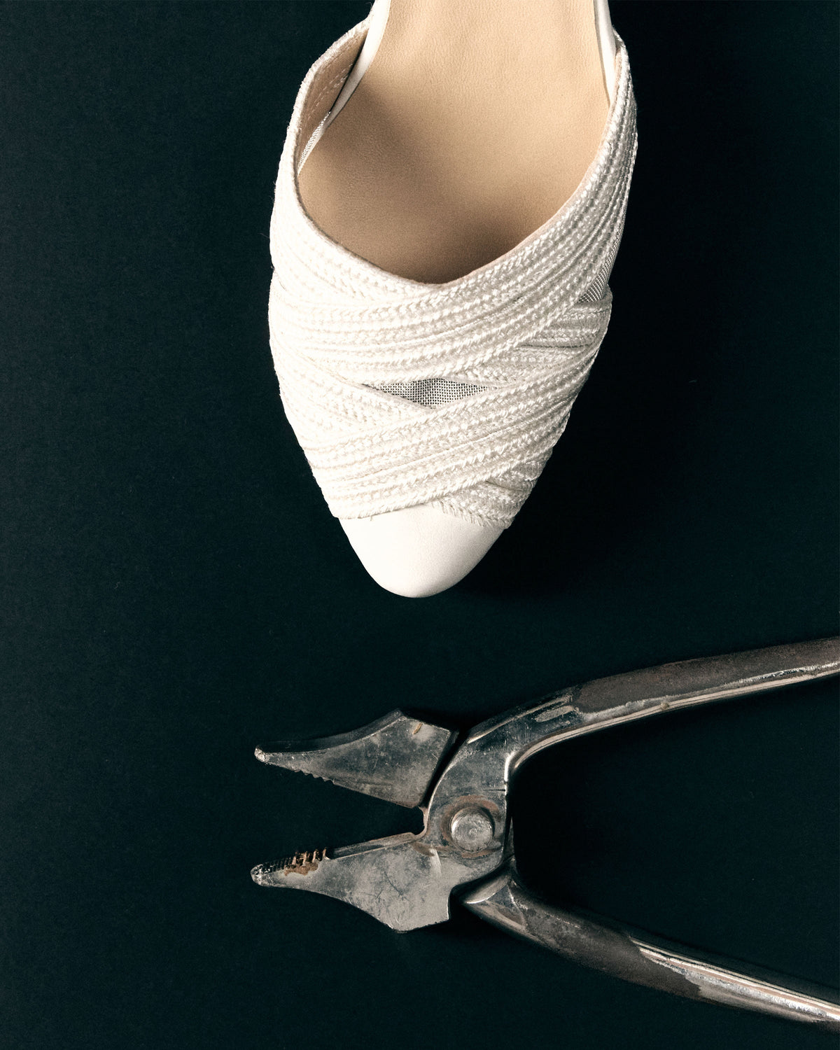 Top view of Joy in White espadrille showcasing braided crisscross toe on black background