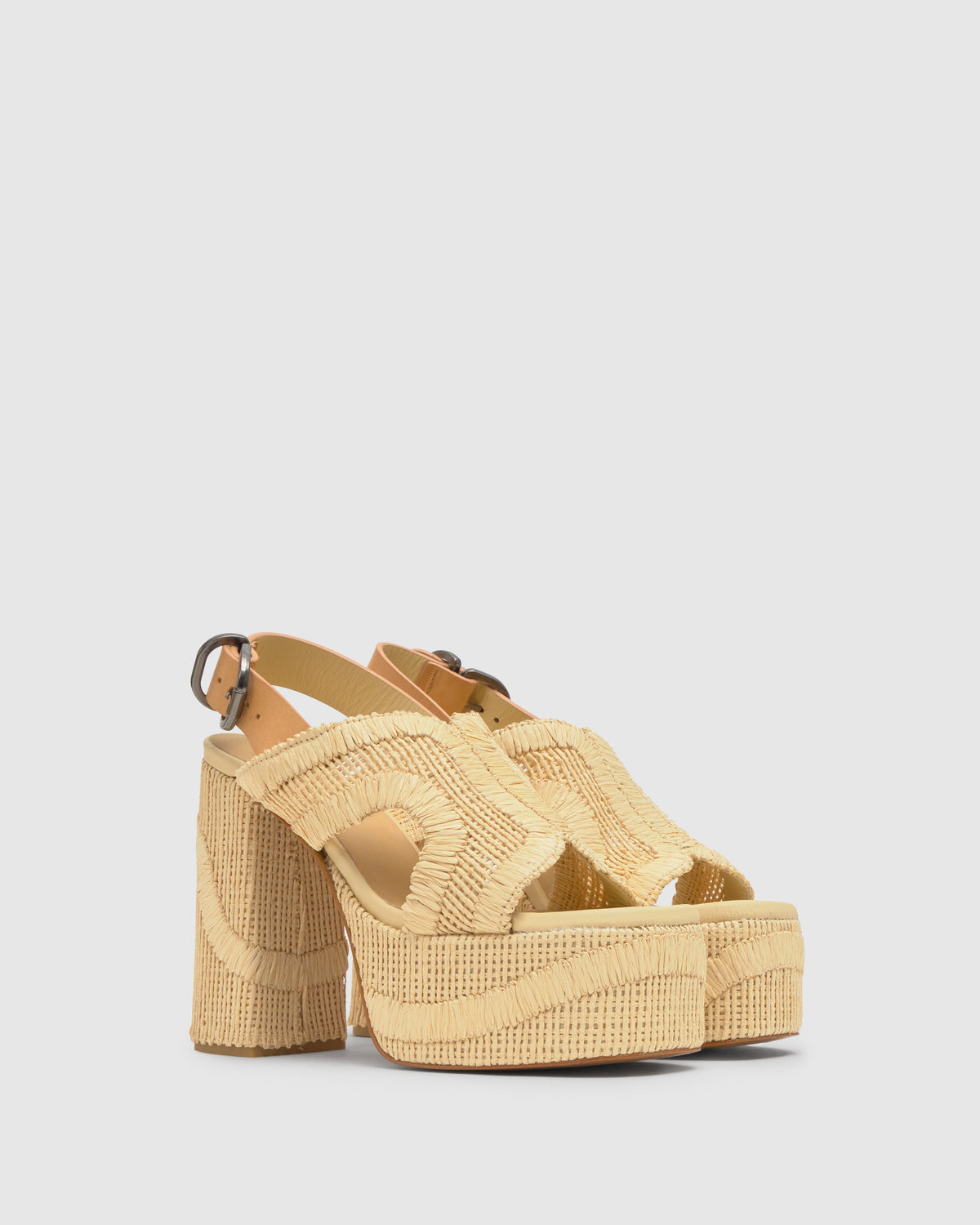 Three-quarter view of Francina wedge sandal in Natural with embroidered raffia upper, jute platform and buckle slingback on gray background
