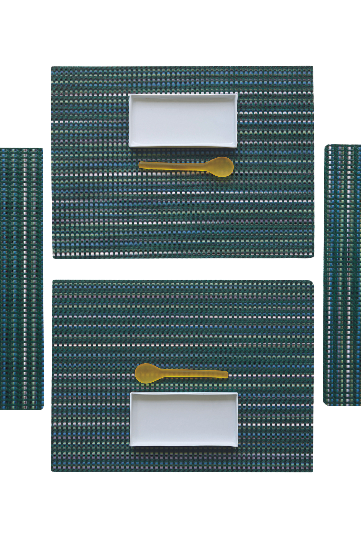 Overhead view of Tambour Placemat showcasing blue-green striped woven texture with plates and spoons on a black background