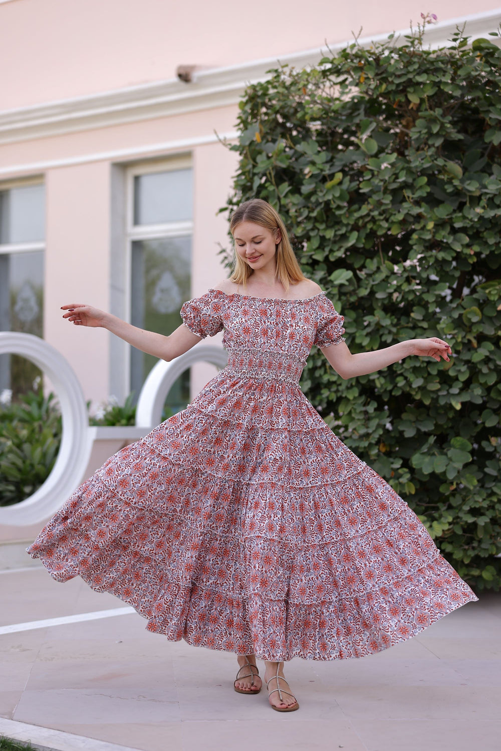 Front view of Santorini Maxi Dress in Pink Tile with off-the-shoulder neckline, smocked waist, and tiered flowing skirt