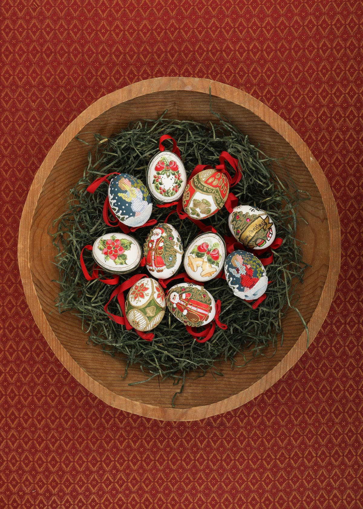 Top view of Hand-Painted Christmas Eggs, Mixed Set of 10 with painted designs and grosgrain ribbons in wooden bowl