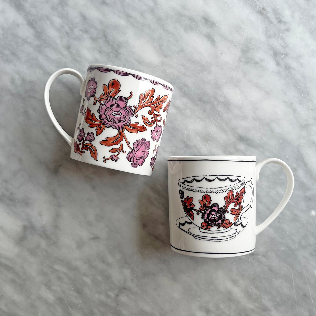 Angled view of Heritage Rosa Rugosa Mug 2 showcasing pink and orange floral hand-applied decals on gray background