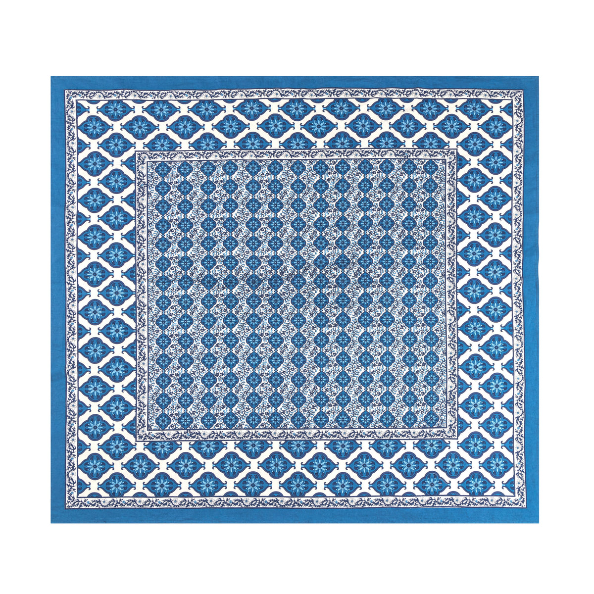 Top view of French Tablecloth Azulejo Blue showcasing blue floral motifs and bordered pattern on white background