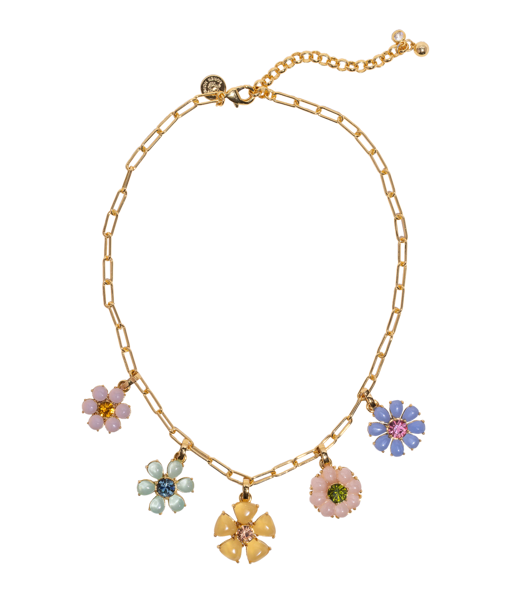 Front view of Talia Charm Necklace showing six pastel flower charms on a gold paperclip chain with adjustable extender on white background