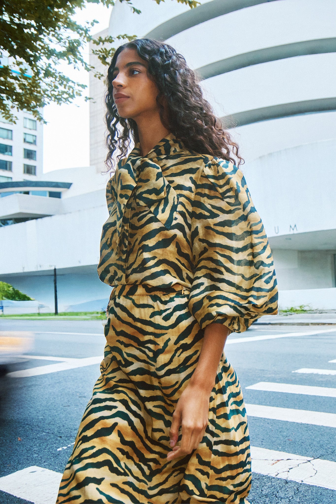 The Tess Blouse in Tiger print, has an elegant tie-front neckline that can be styled into a bow.