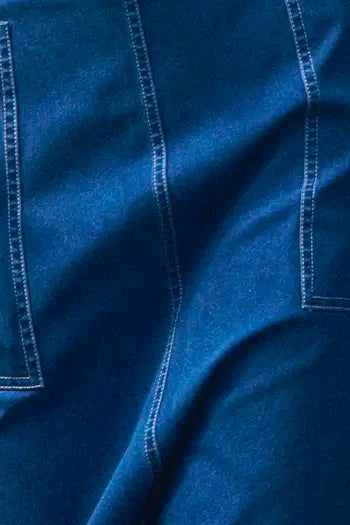 Denim midi skirt framed by patch pockets with crisp topstitching and a removable belt with a D-ring.